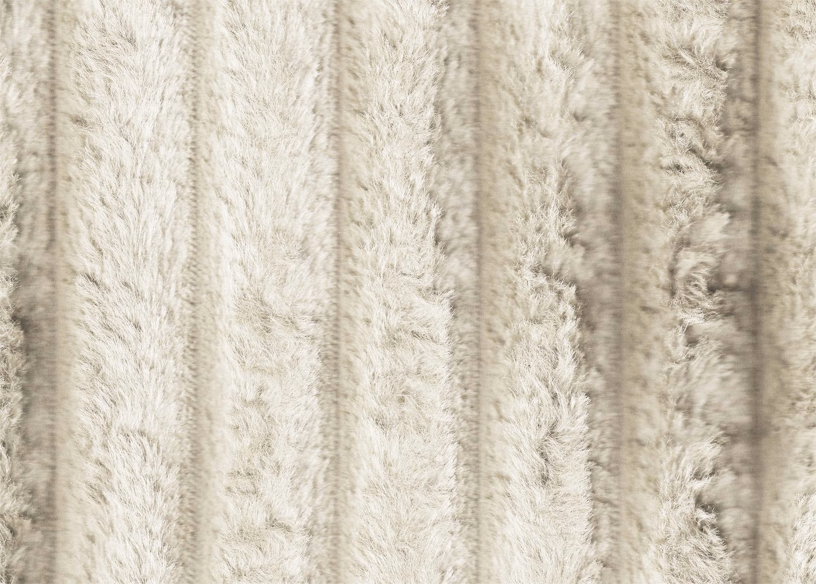Warm ivory faux fur with shaggy vertical channels and soft cream-grey pile shadows