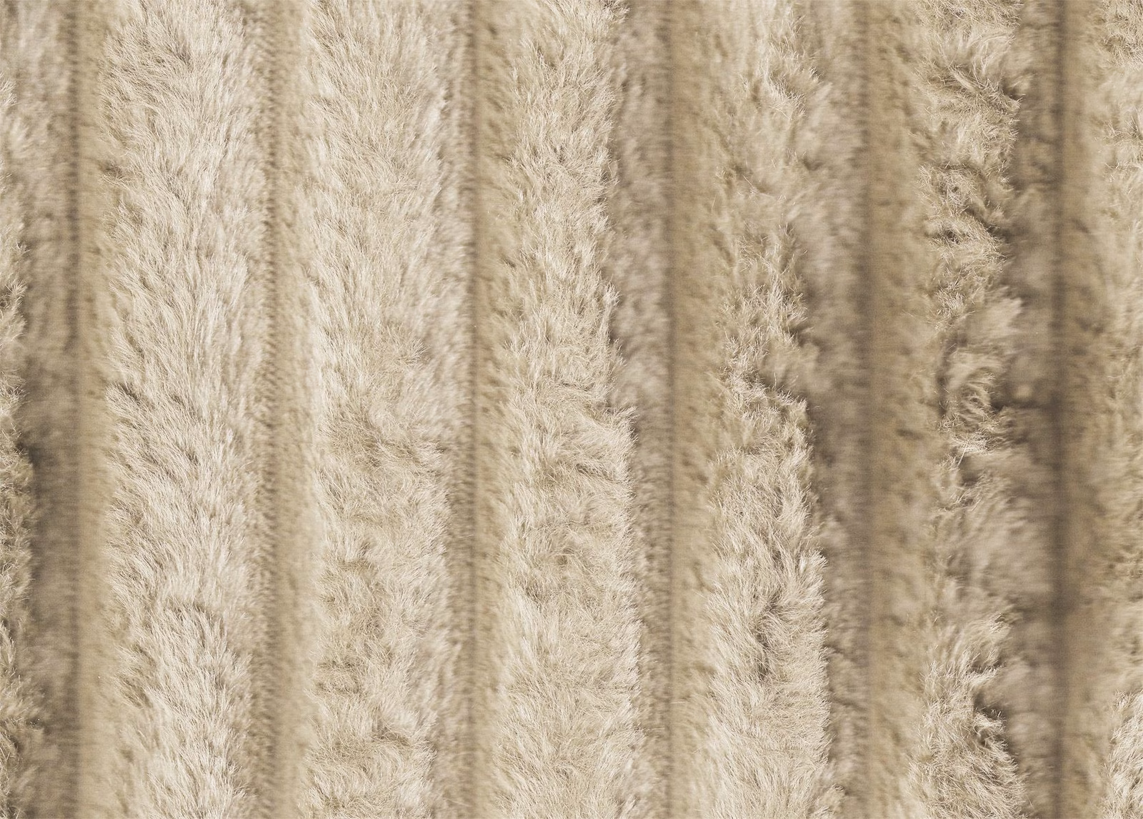 Pale beige-taupe faux fur with shaggy vertical ribs and softly shadowed pile