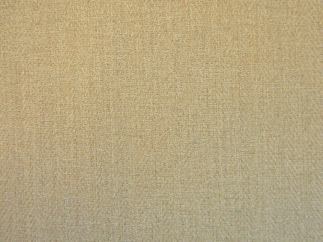 Close-up of muted oatmeal-beige chenille with a fine, softly mottled woven texture