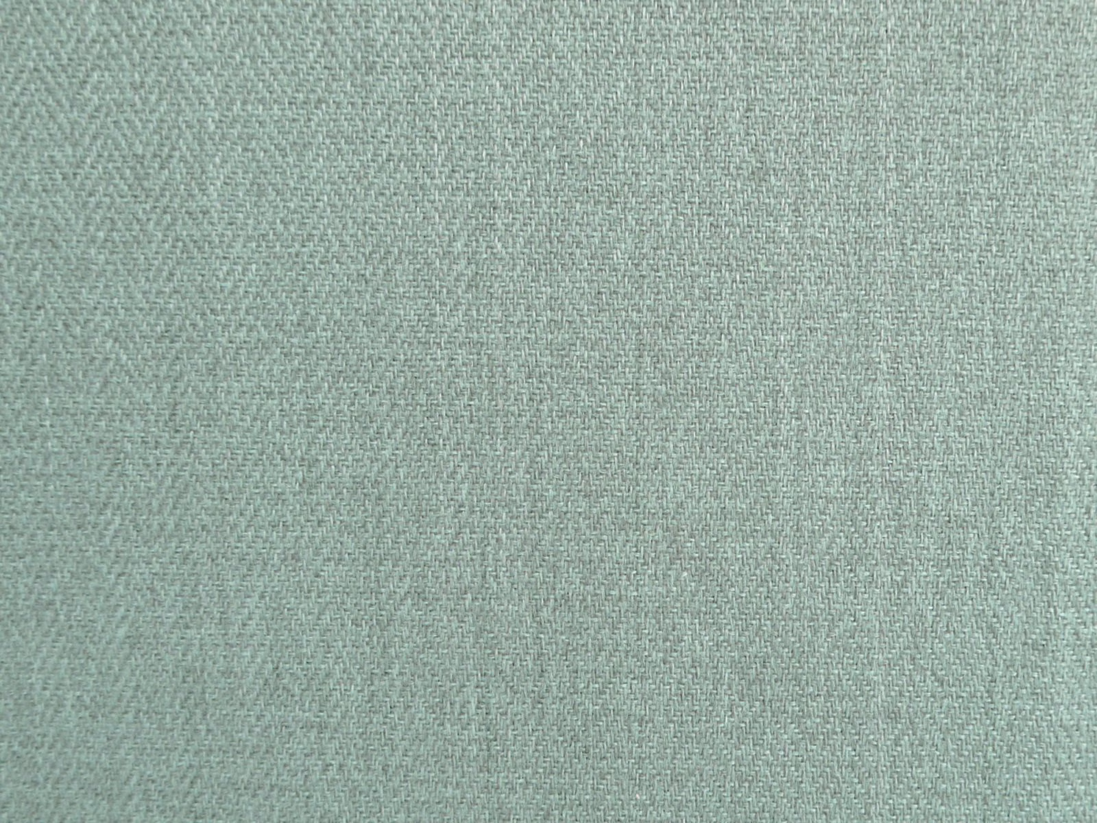 Close-up of muted sage-green chenille with a fine diagonal woven texture