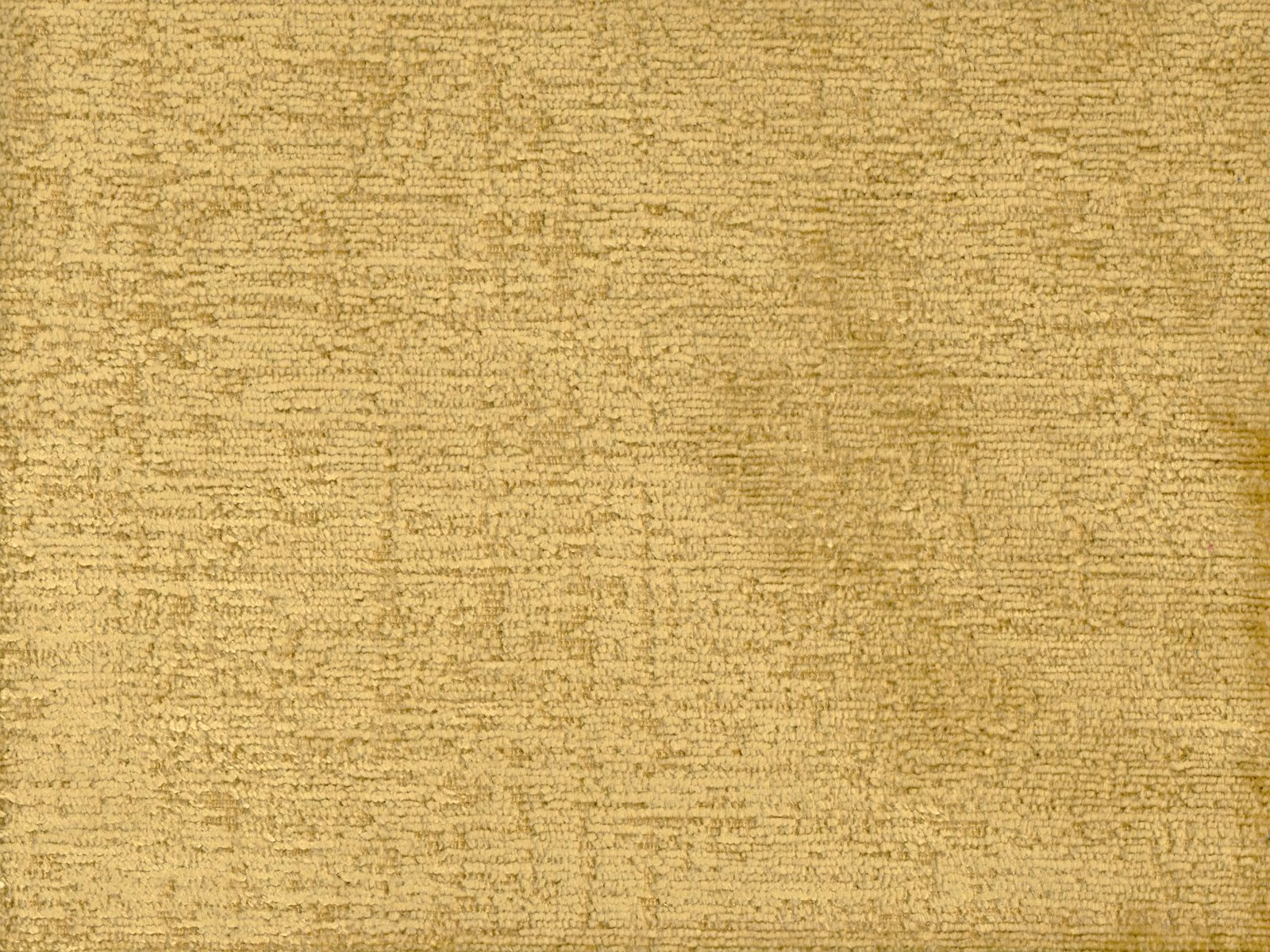 Close-up of muted straw-gold chenille with irregular horizontal slub texture