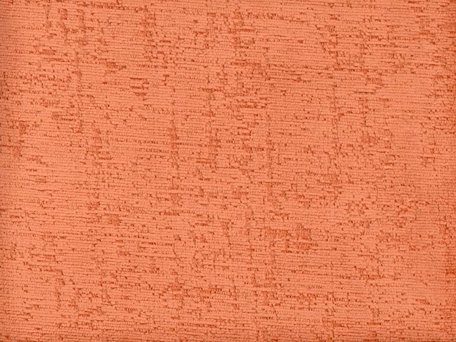 Warm coral terracotta chenille with irregular horizontal slub texture