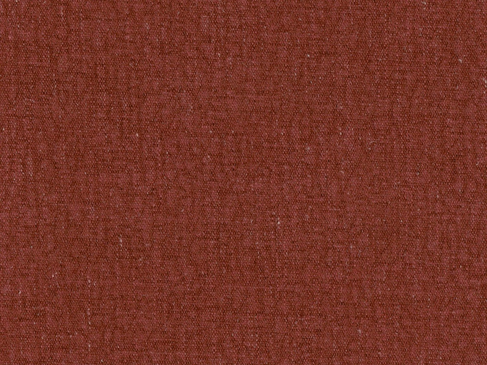 Muted rust terracotta flat weave with subtle tonal crosshatch texture