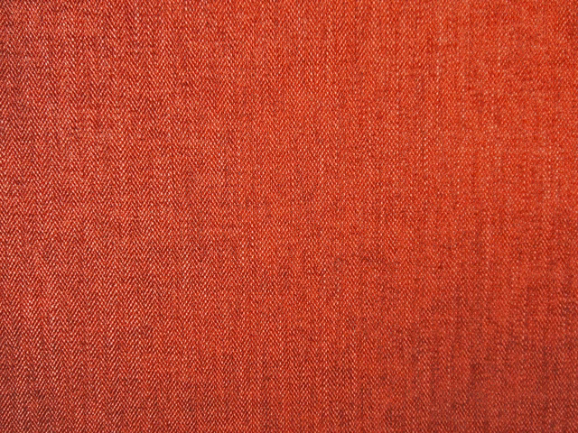 Warm terracotta red chenille with fine chevron weave and subtly varied texture