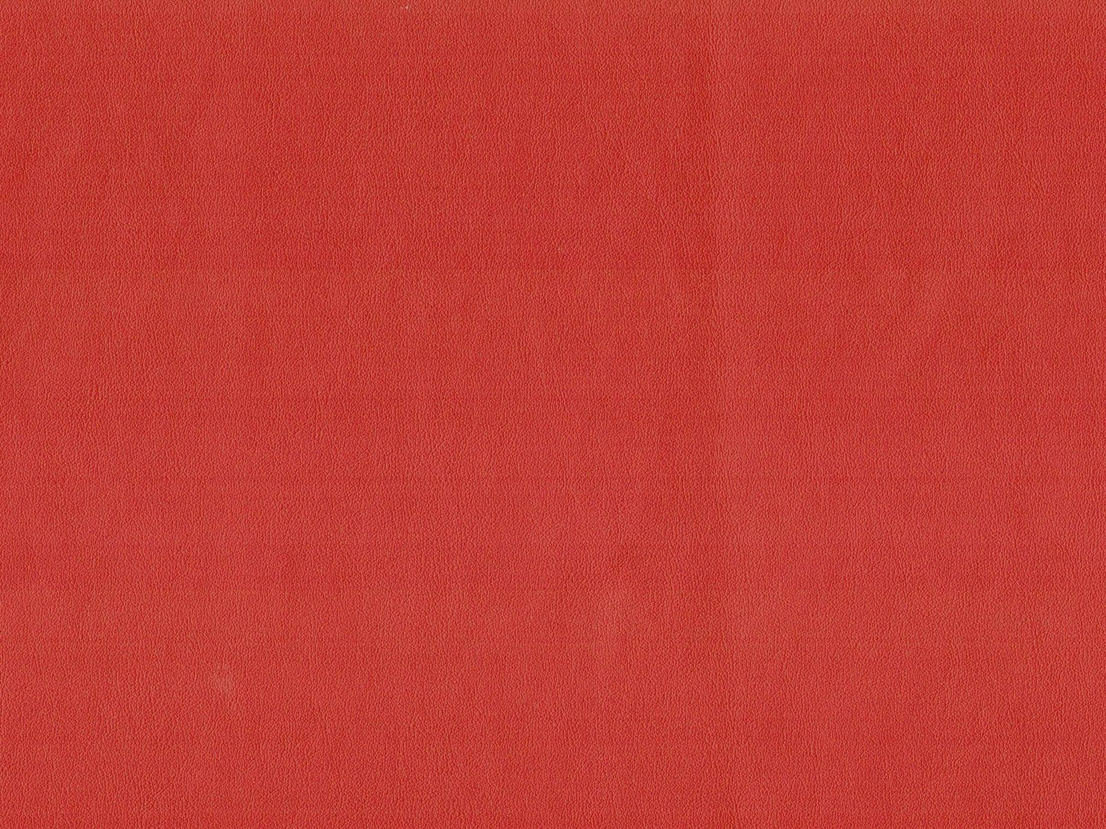 Saturated warm red faux leather with a softly mottled, low-sheen surface