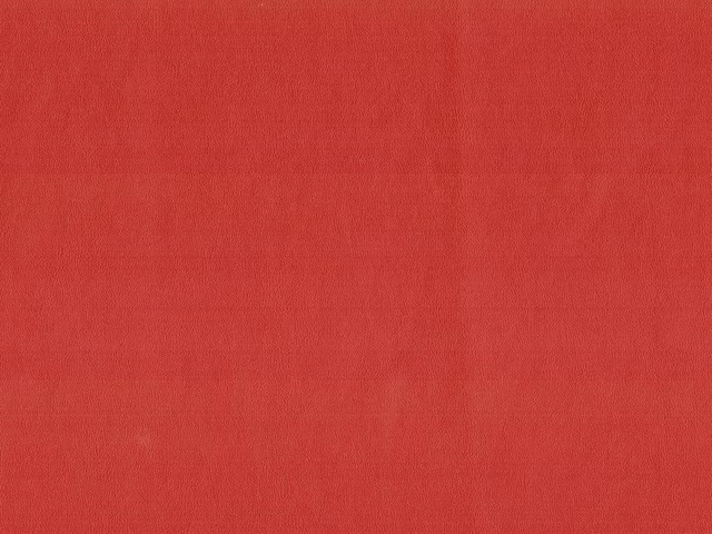 Saturated warm red faux leather with a softly mottled, low-sheen surface