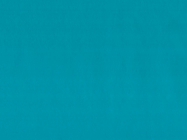 Close-up of vivid turquoise teal faux leather with a subtle fine grain