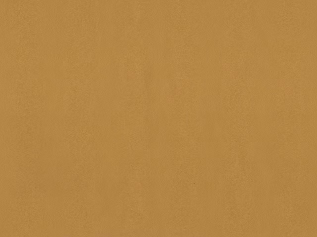 Warm ochre faux leather swatch with subtle vertical grain and soft sheen