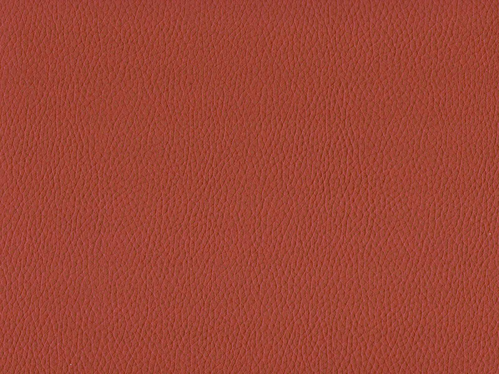 Muted terracotta-red faux leather with fine pebbled grain and subtle surface sheen