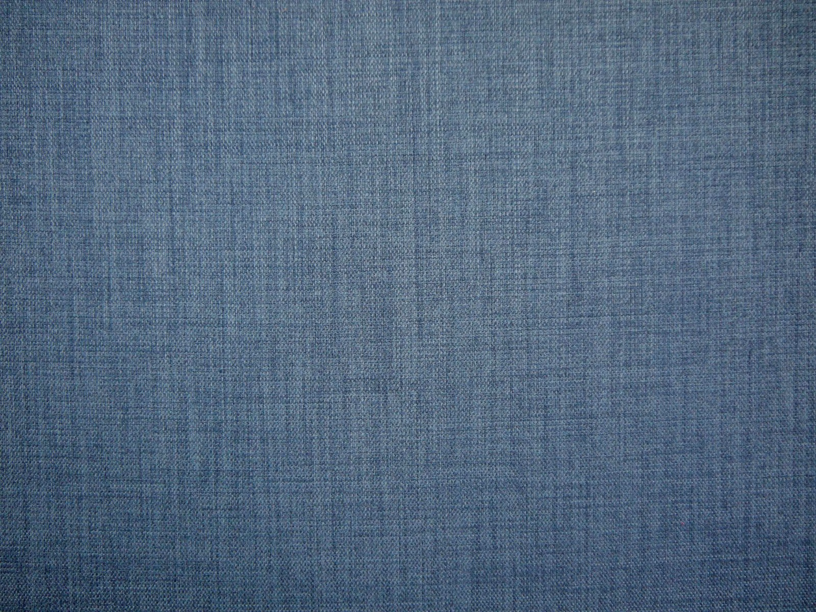 Muted slate-blue flat weave with a fine crosshatched texture and softly varied threads