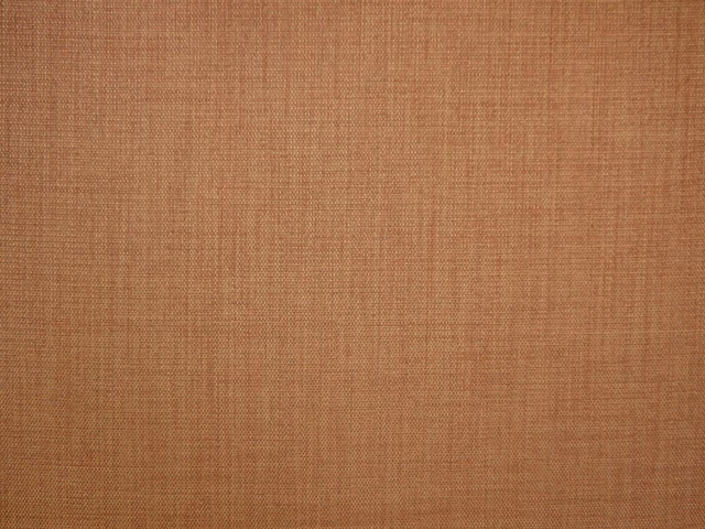 Warm terracotta flat-weave textile showing a fine, even crosshatch texture