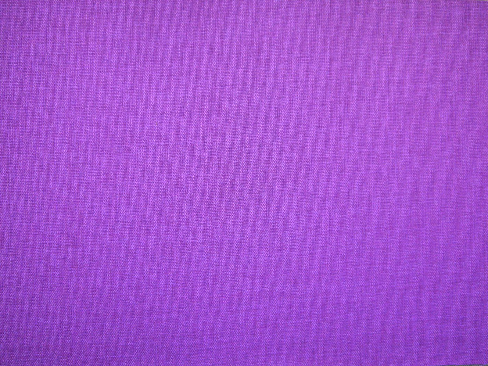Close-up of vivid violet-purple flat weave with fine magenta crosshatch texture