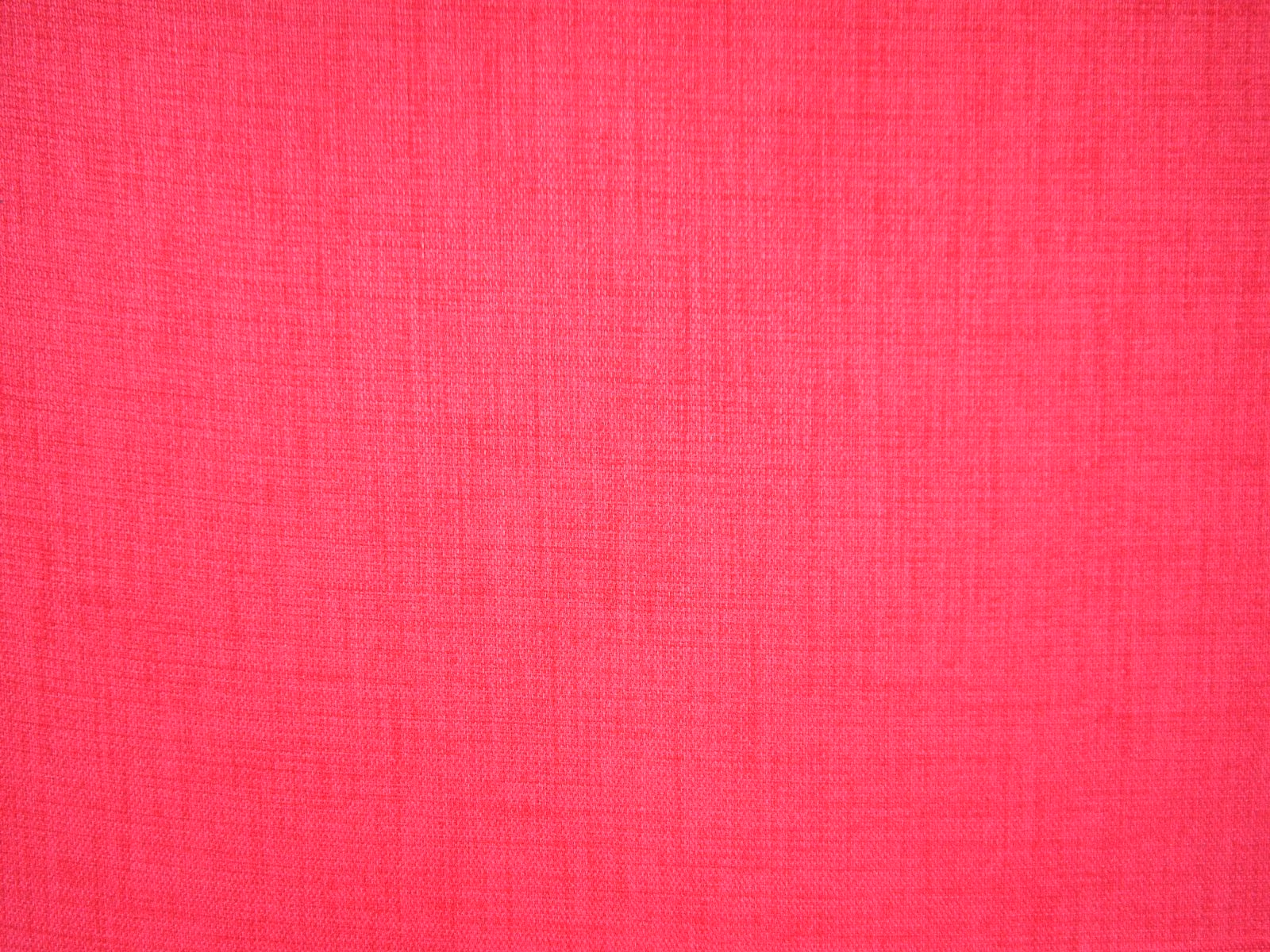 Close view of vivid raspberry-pink flat weave with a fine crosshatched texture