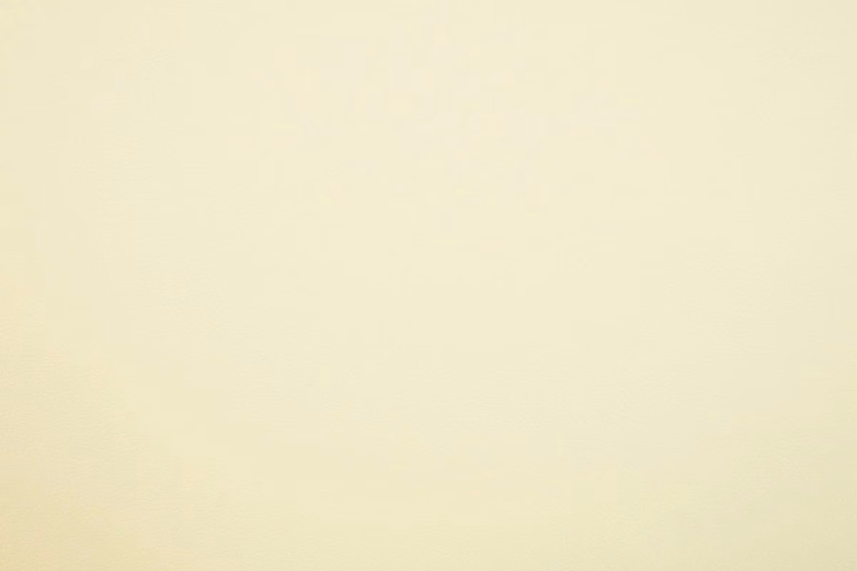 Pale ivory cream faux leather with a soft, near-smooth surface