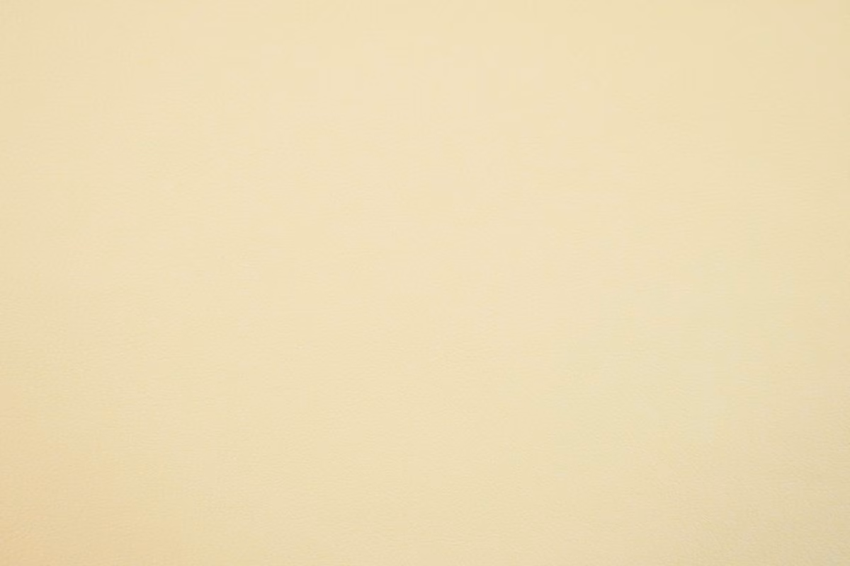 Pale warm cream faux leather with a smooth, subtly grained surface