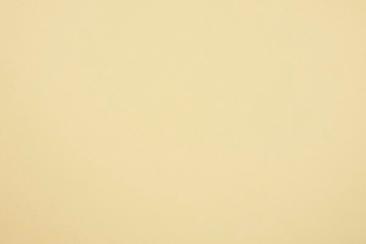Pale buttery cream faux leather with a smooth, softly luminous surface