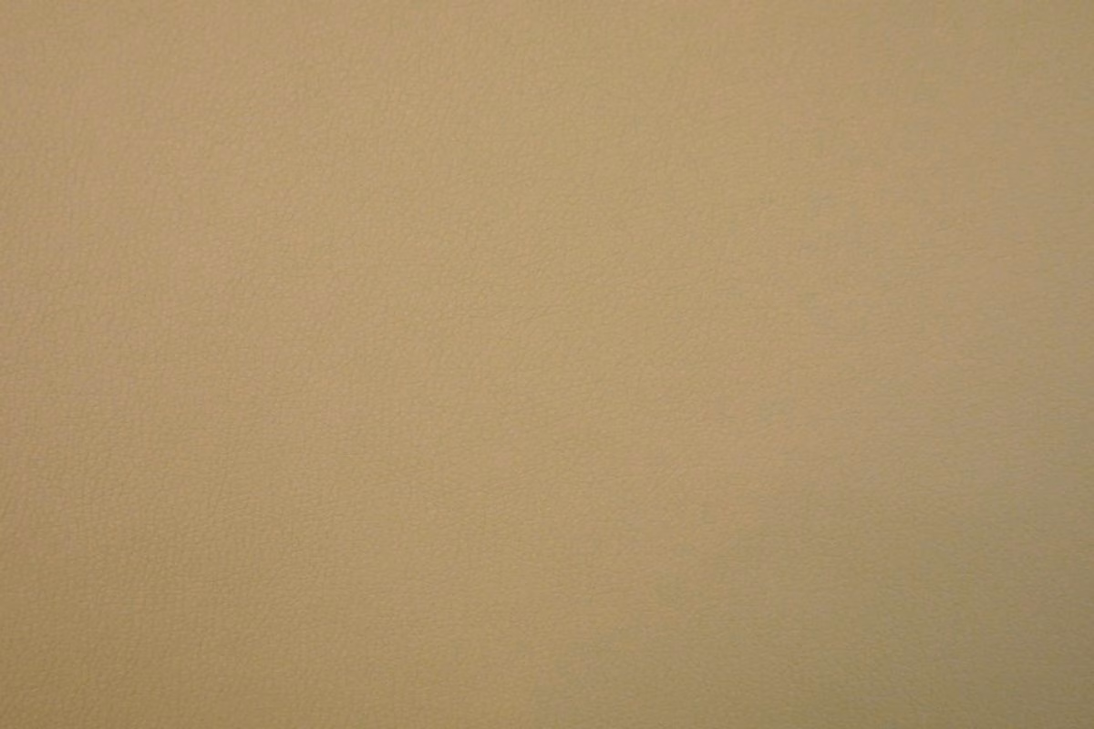 Muted sandy beige faux leather with a fine, even grain and subtle sheen