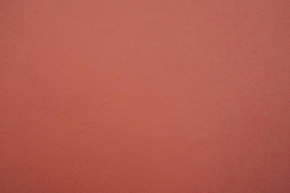 Muted terracotta-red faux leather with a subtle fine-grain surface
