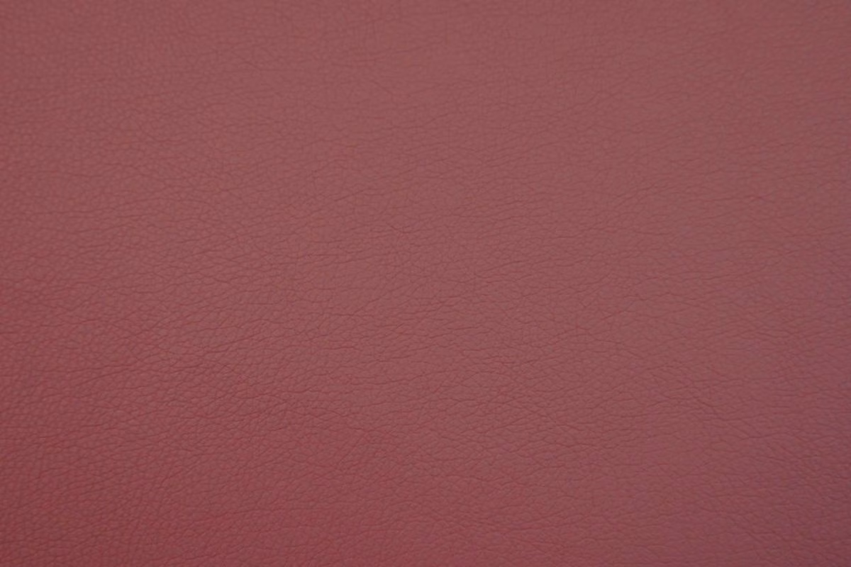 Muted burgundy faux leather with a fine pebbled grain and soft sheen