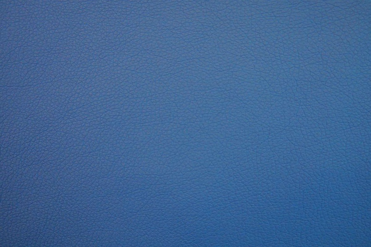 Muted slate-blue faux leather with fine pebbled grain and subtle tonal variation