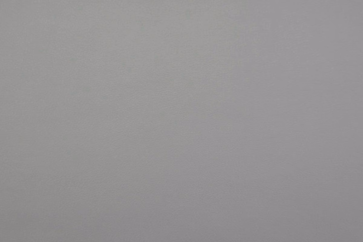 Cool mid-grey faux leather swatch with a subtle fine-grain texture