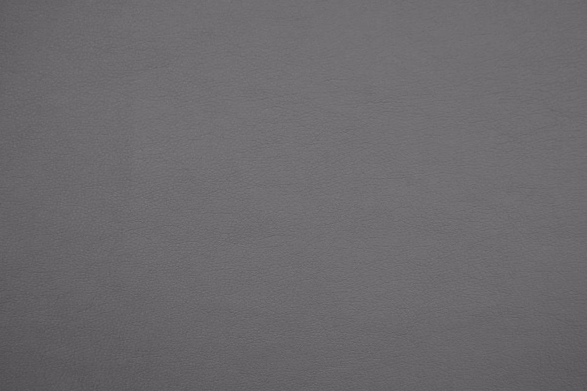 Deep charcoal-grey faux leather swatch showing a fine, subtly mottled surface grain