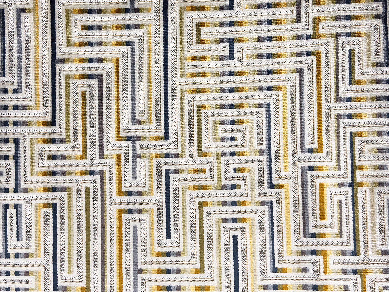 Cream velvet with charcoal, grey and ochre interlocking maze lines
