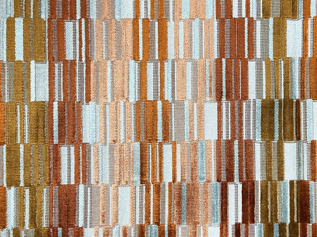 Textured multicolour velvet with stacked rust, ochre, cream and pale blue rectangular blocks