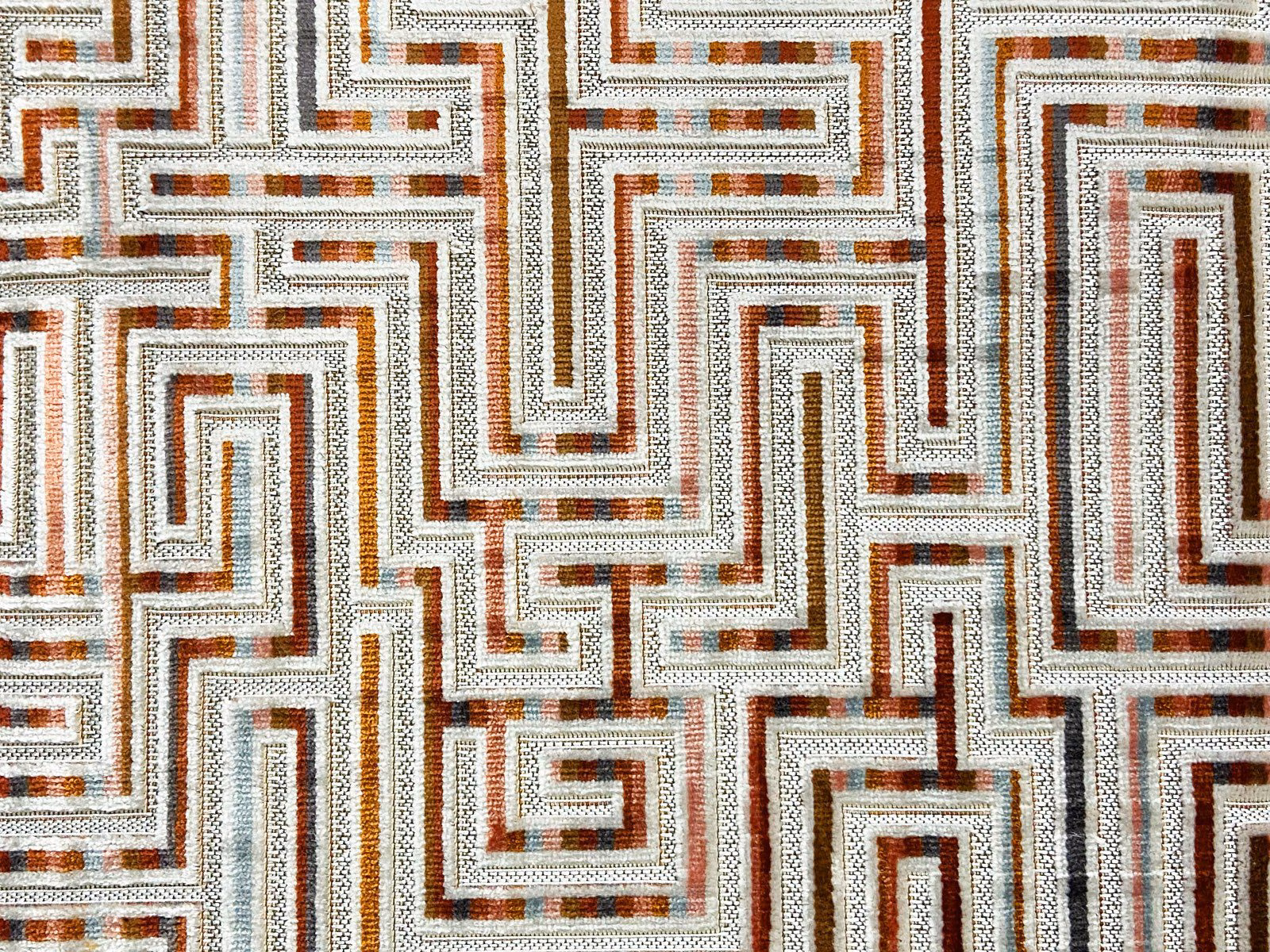 Ivory velvet with interlocking rust, brown and slate geometric maze lines
