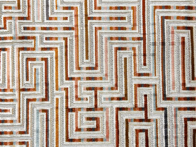Ivory velvet with interlocking rust, brown and slate geometric maze lines