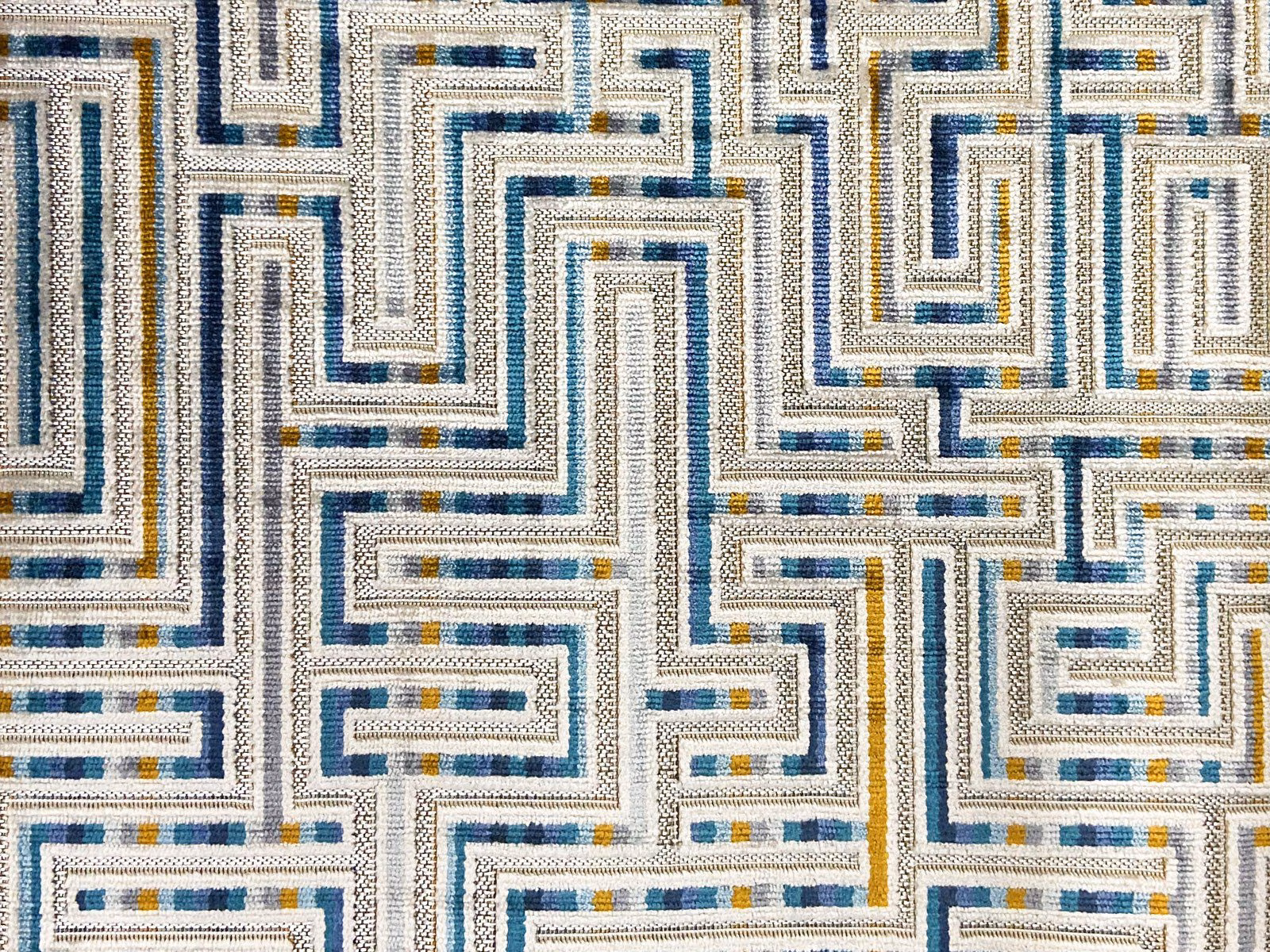 Cream velvet with navy, teal and mustard maze lines in a textured weave