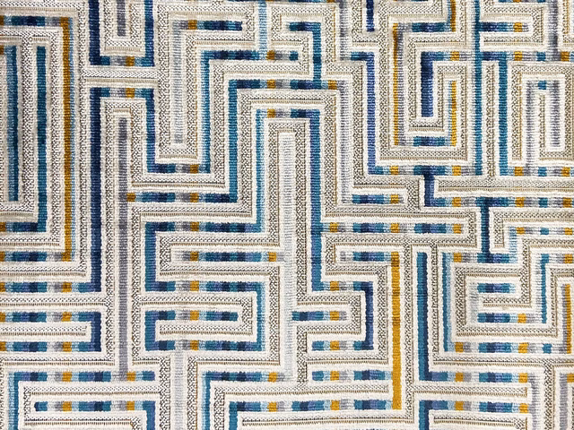 Cream velvet with navy, teal and mustard maze lines in a textured weave