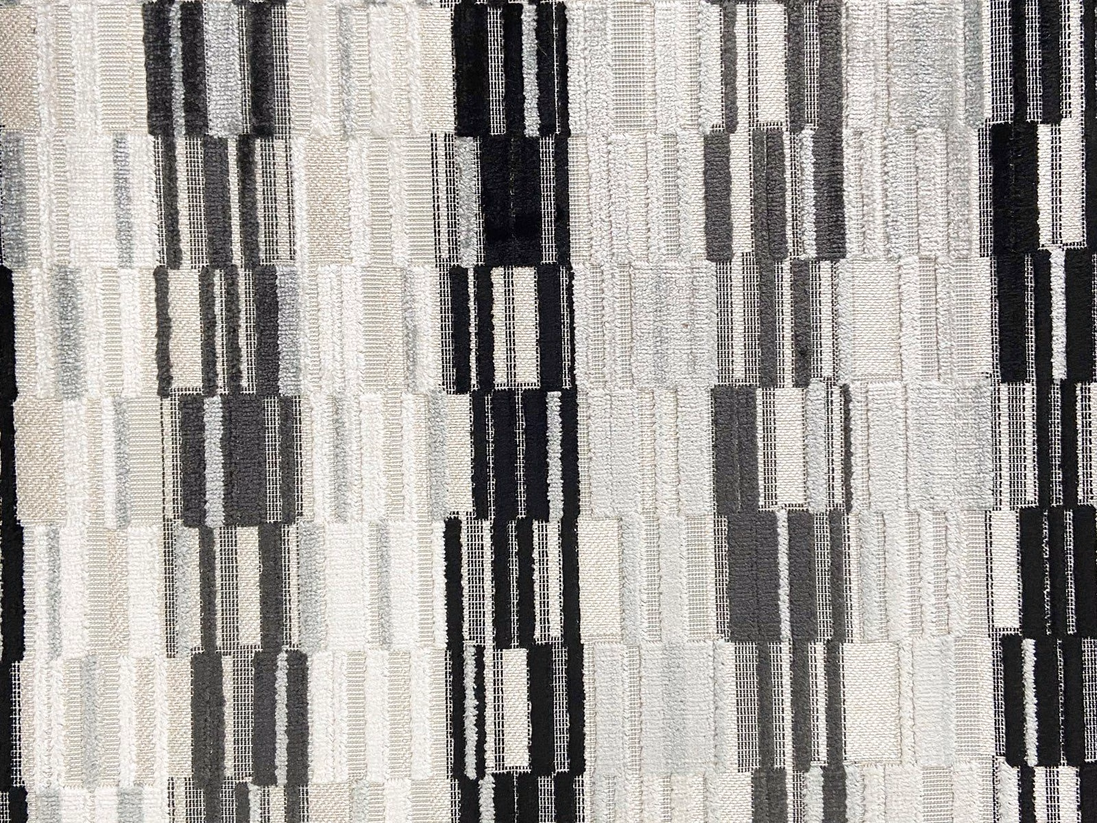 Cool grey velvet with black, white and charcoal geometric vertical blocks
