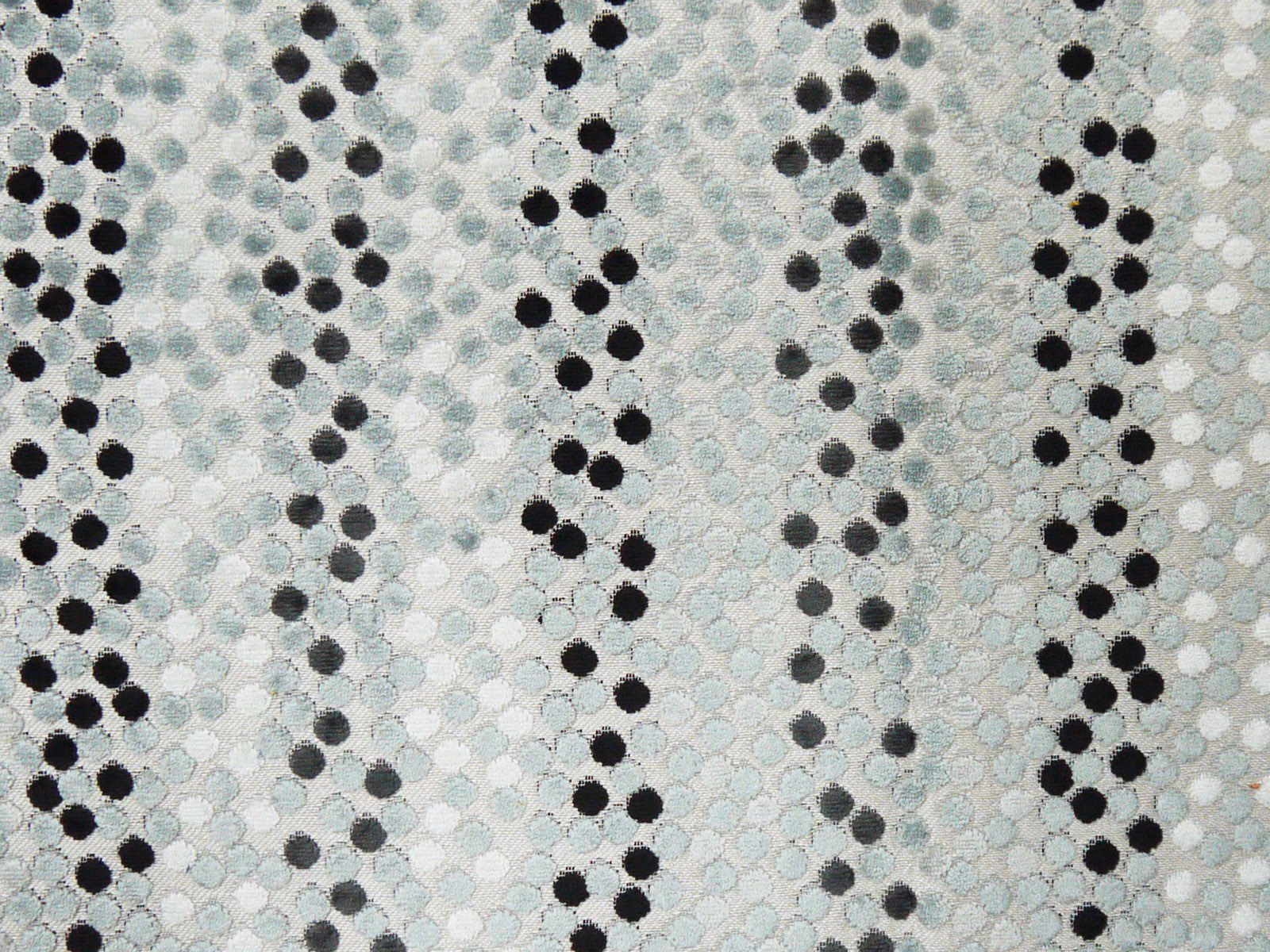 Pale aqua velvet with vertical trails of charcoal and black circular dots