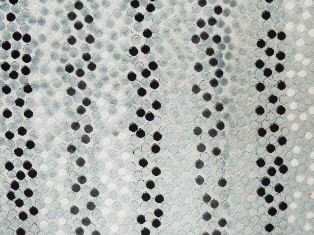 Pale aqua velvet with vertical trails of charcoal and black circular dots