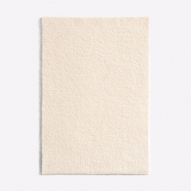 Warm ivory chenille swatch with a fine nubby weave and subtle vertical texture