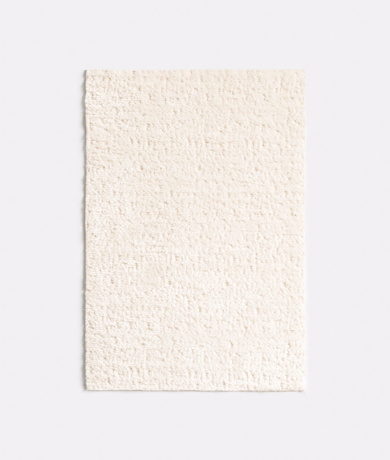 Warm off-white chenille swatch with a dense, softly nubby woven surface