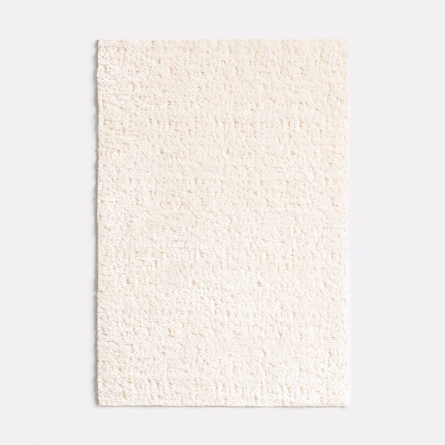 Warm off-white chenille swatch with a dense, softly nubby woven surface