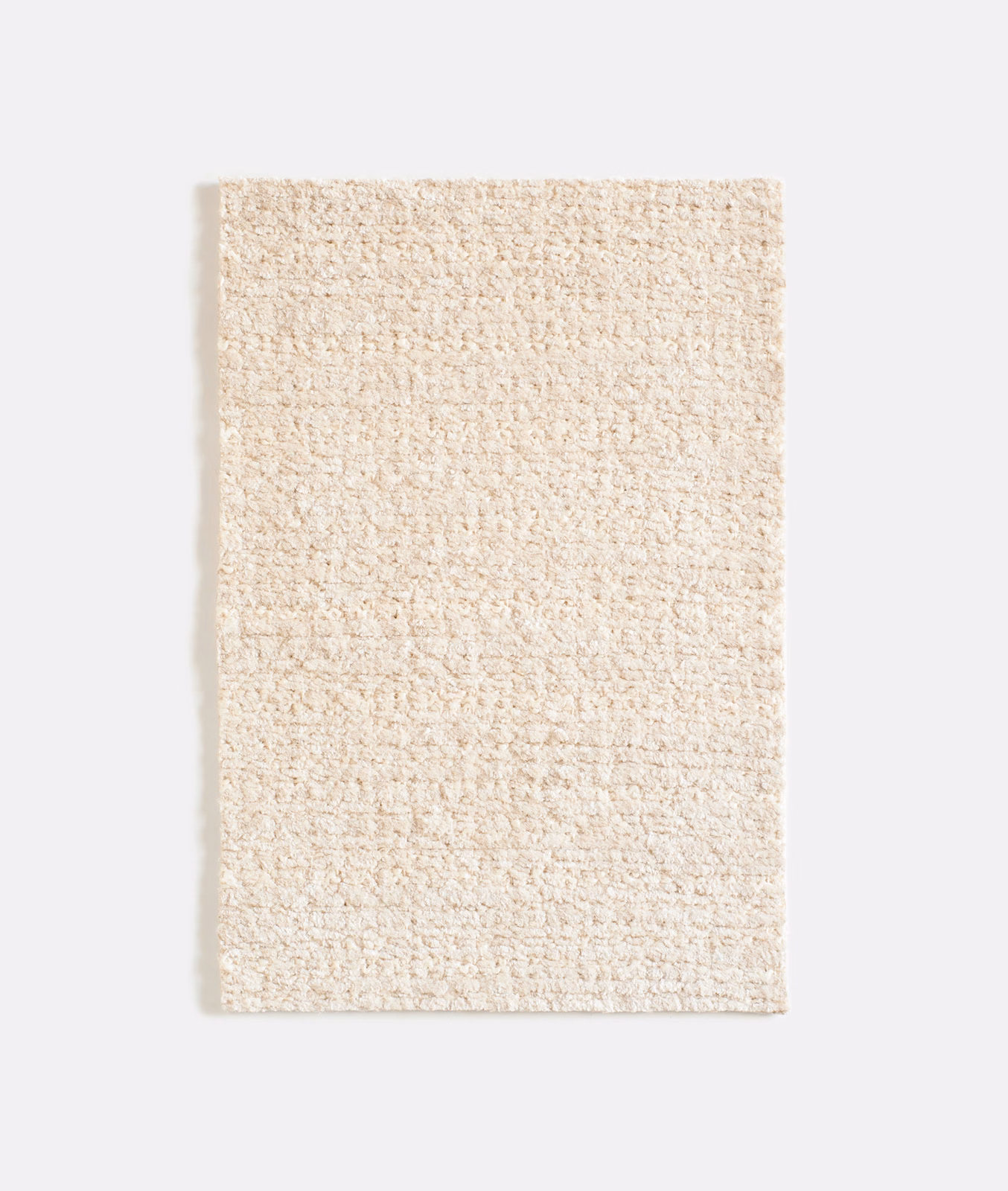 Warm sand-beige chenille swatch with dense nubby loops and softly mottled texture