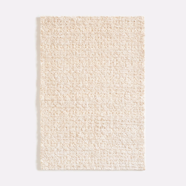 Warm sand-beige chenille swatch with dense nubby loops and softly mottled texture