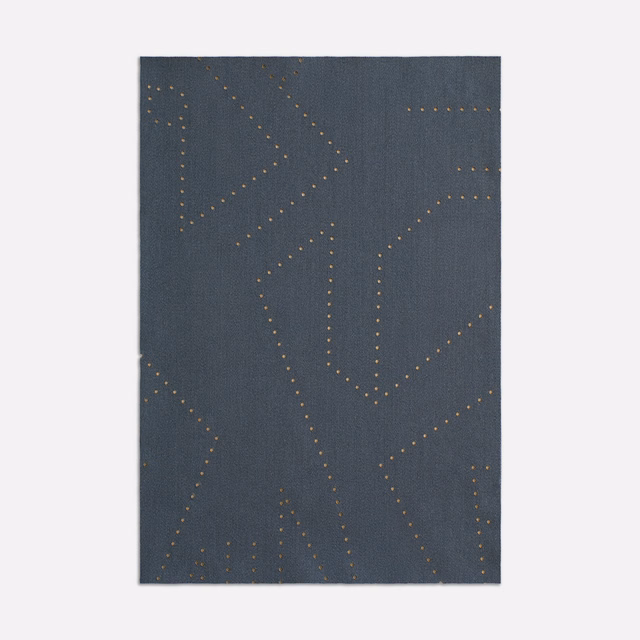 Deep slate-blue woven fabric with muted gold dotted, angular branching lines.