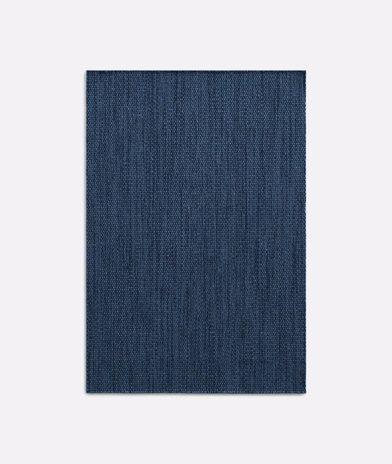 Deep indigo woven curtain fabric with fine vertical striations and subtle tonal texture