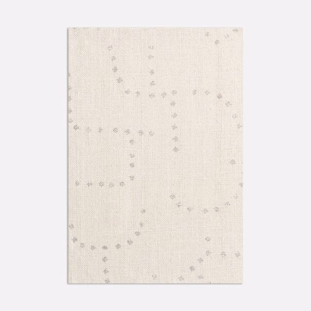 Pale ivory woven cloth with cool-grey dotted loops and a softly textured surface