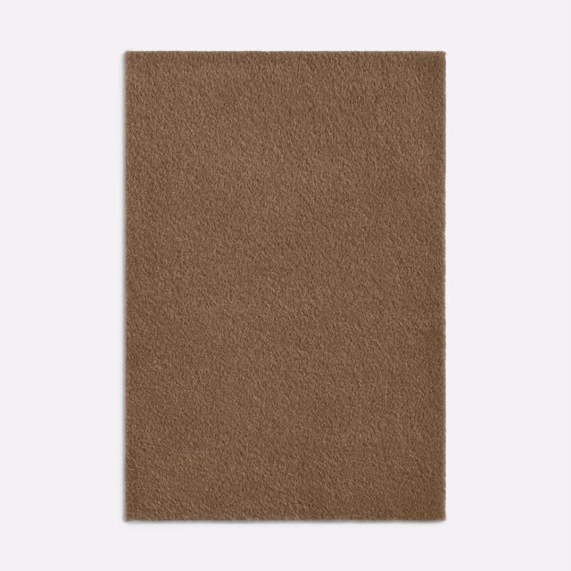 Close swatch of warm camel-brown fabric with a soft, densely brushed alpaca-like texture