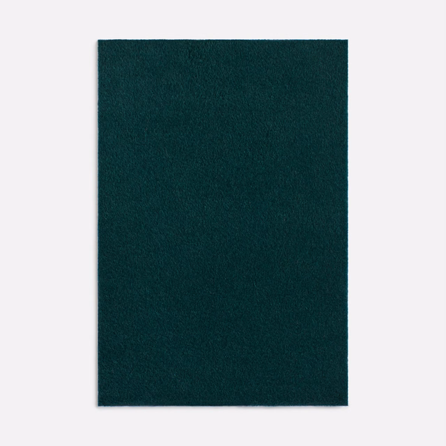 Deep forest-green Dedar fabric swatch with a softly brushed, tonal plain texture