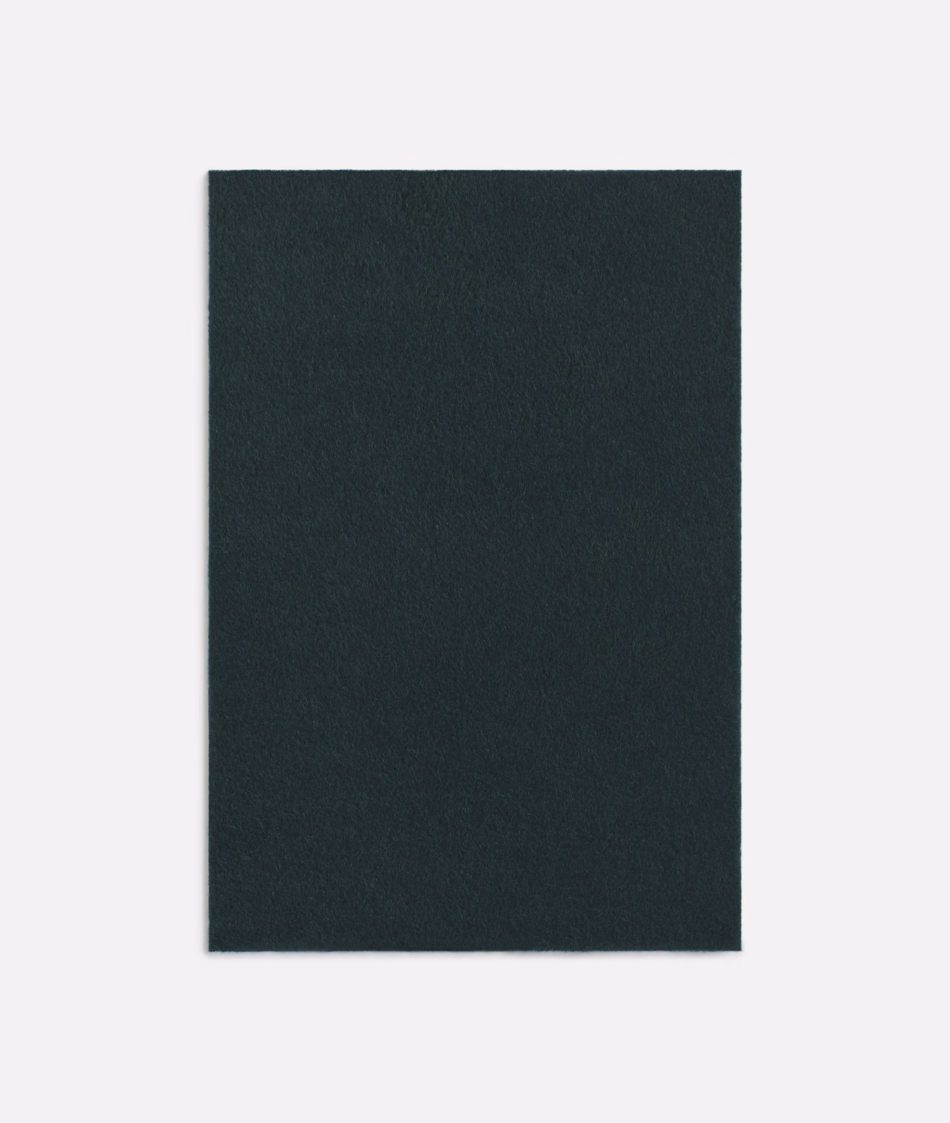 Dense deep forest-green loden textile with a softly fleeced, matte surface