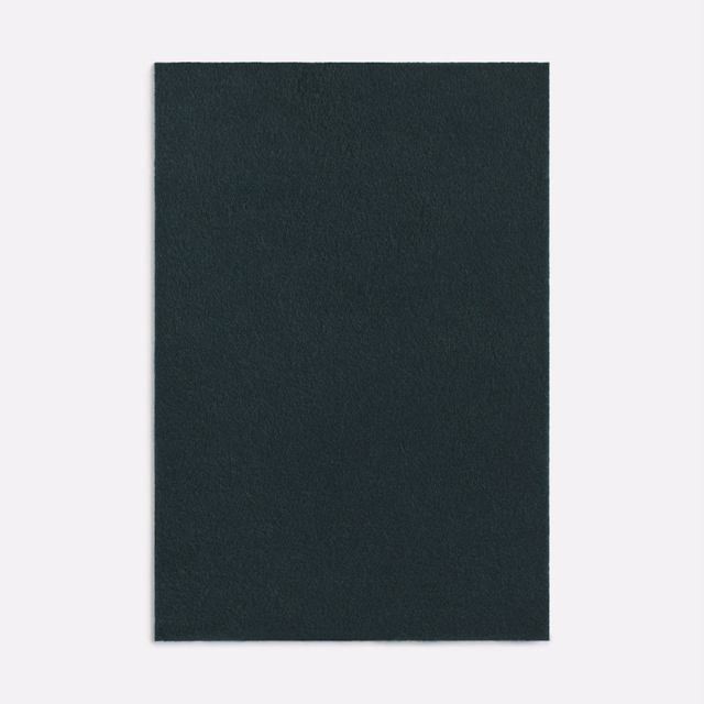 Dense deep forest-green loden textile with a softly fleeced, matte surface