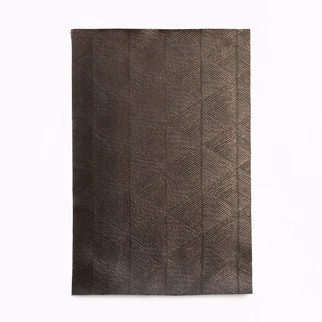 Deep bronze-brown curtain fabric with fine herringbone lines and angular panel divisions