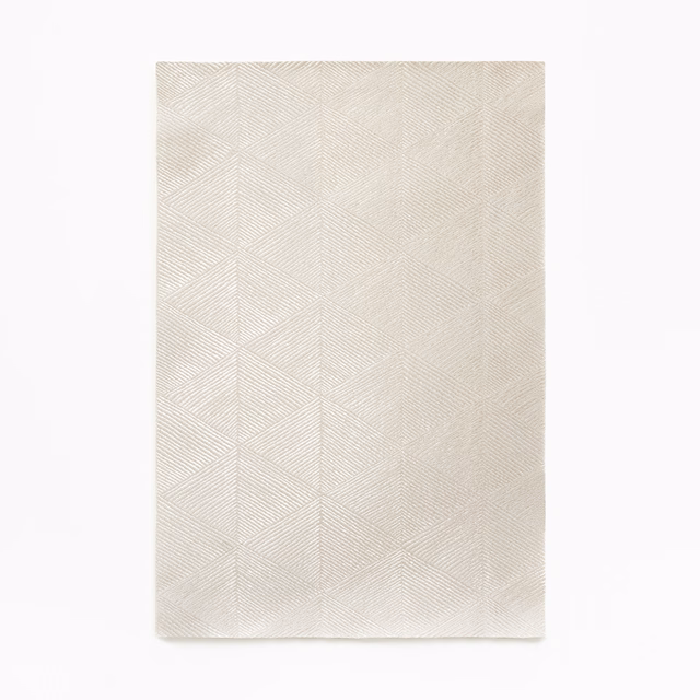 Pale ivory curtain fabric with fine chevron-like geometric woven texture
