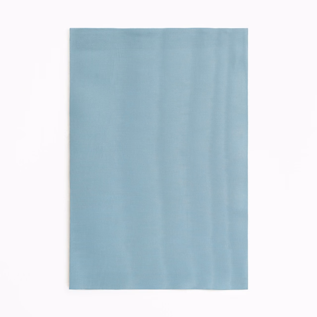 Pale aqua-blue curtain fabric with fine vertical tonal ripples and a soft sheen
